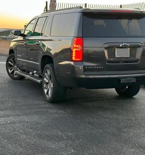 a black suv parked in a parking lot