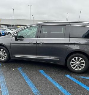a silver van parked in a parking lot