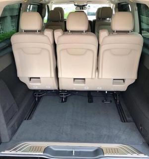 an open trunk of a minivan with the back seats open