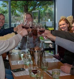 a group of people holding up wine glasses