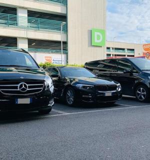 three cars parked in a parking lot in front of a building