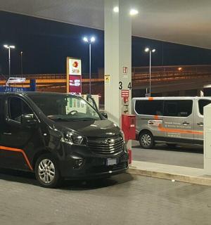 a black van parked at a gas station at night