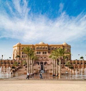 a large building with a fountain in front of it