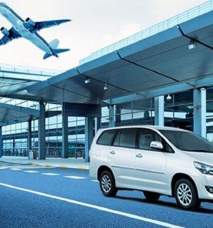 a white van parked in front of an airport