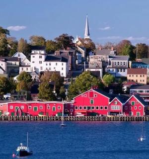 a town with red houses on the shore of the water