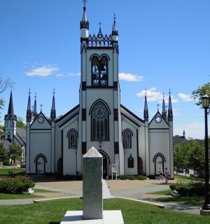 a church with a clock tower in front of it