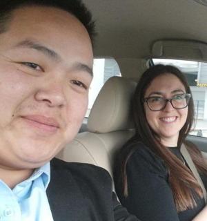 a man and a woman sitting in a car