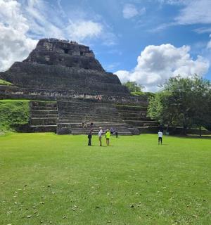 a group of people standing in front of a pyramid