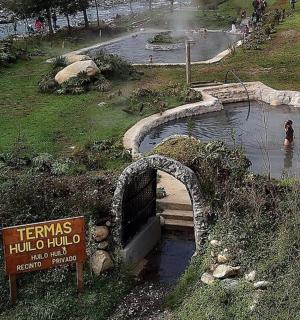 a small pond in a park with a person in the water