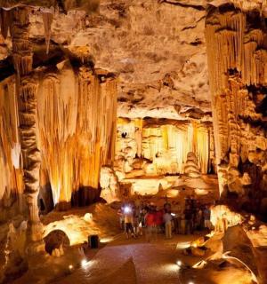 a group of people standing in a cave