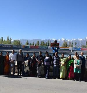 a group of people posing for a picture on a bridge