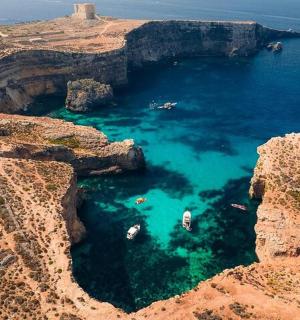 an aerial view of a cove with boats in the water