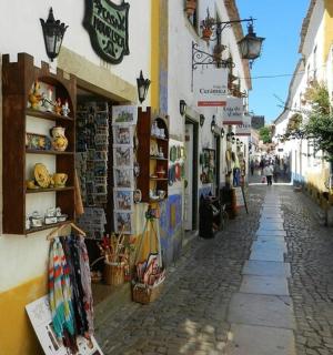 a narrow street with a shop on the side of a building