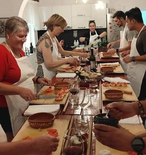 a group of people standing around a table with food