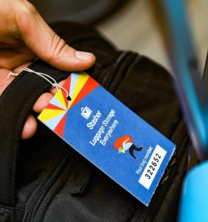a person holding a tag on a bag