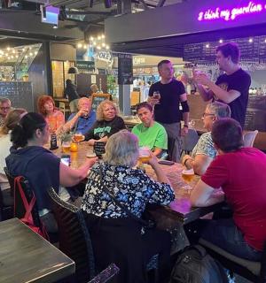 a group of people sitting at tables in a restaurant