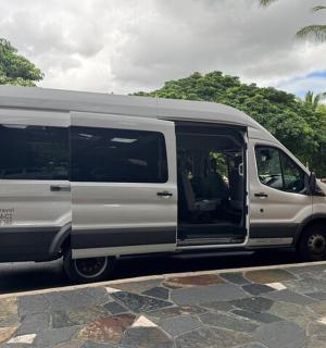 a white van driving down a street with palm trees