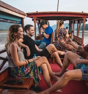 a group of people sitting in the back of a boat