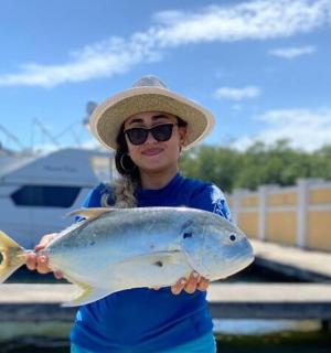 一名妇女手里拿着一条鱼