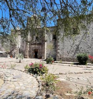 an old stone building with a stone path in front