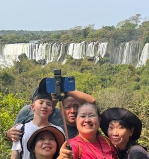 a group of people standing in front of a waterfall
