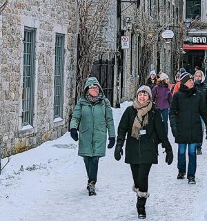 a group of people walking down a street in the snow