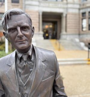 a statue of a man in a suit and tie
