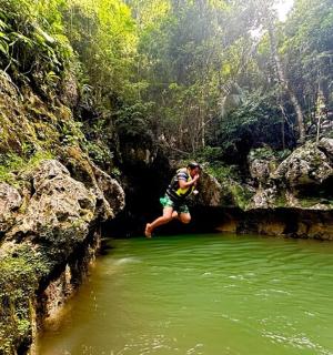 a man sitting on a rock in a body of water