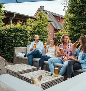 a group of people sitting on a bench with a dog