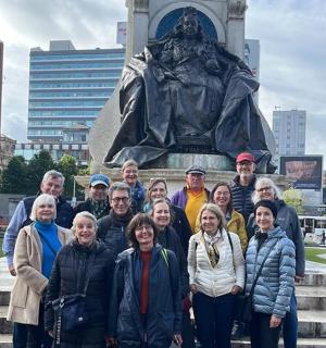 a group of people standing in front of a statue