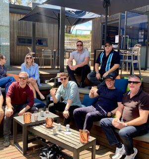 a group of people posing for a picture on a patio