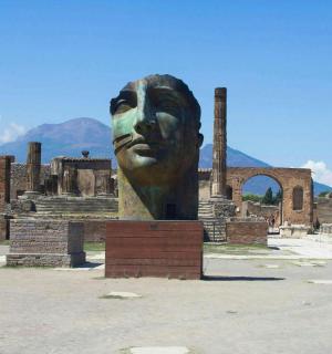 a large statue of a face in front of a building
