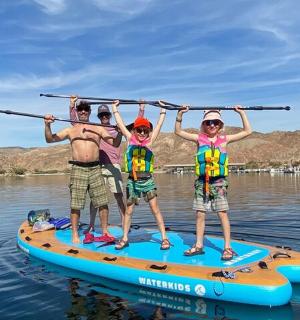 a group of people on a paddle board on the water
