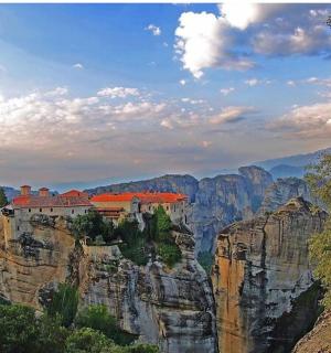 a house on the edge of a mountain cliff