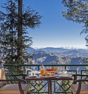 a table and chairs on a balcony with a view