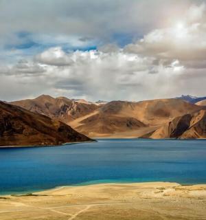 a view of a lake in the middle of mountains
