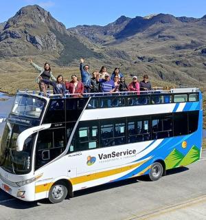 a group of people riding on top of a bus