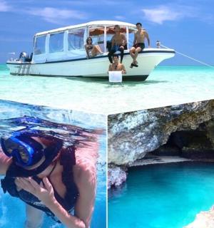 一名男子在船旁的水中游泳