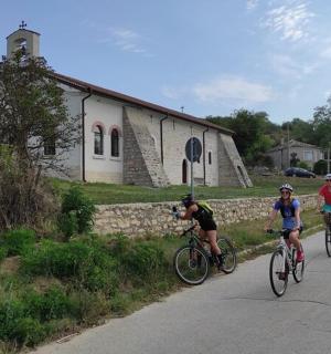 a group of people riding bikes down a road