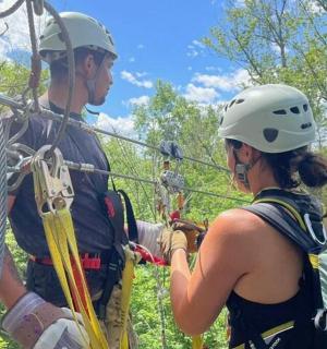 a man and a woman on a zip line