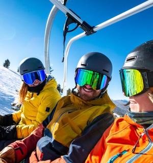 a group of people sitting on a ski lift