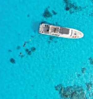 an aerial view of a boat in the ocean