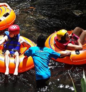 a group of people rafting down a river