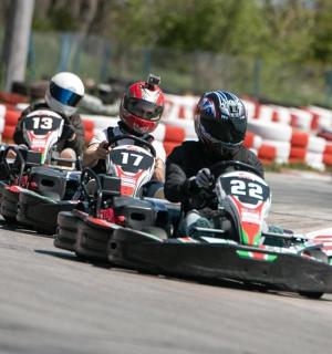 a group of people riding inailed cars on a race track