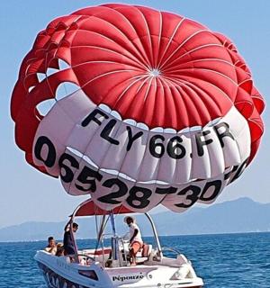 a hot air balloon flying over a boat in the water