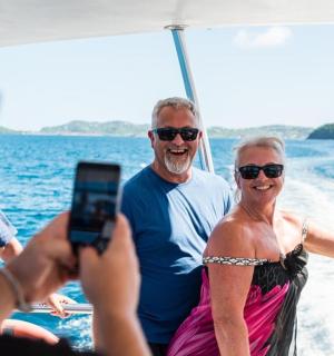 muž fotící ženu na lodi