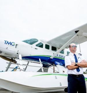 a man standing in front of a small plane