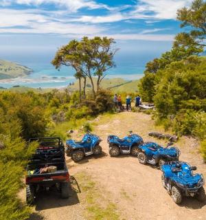 a group of four atvs parked on a dirt road