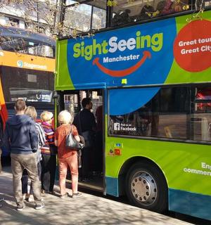 a group of people getting on a bus