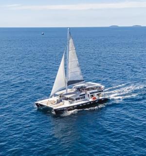 a small sailboat in the middle of the water